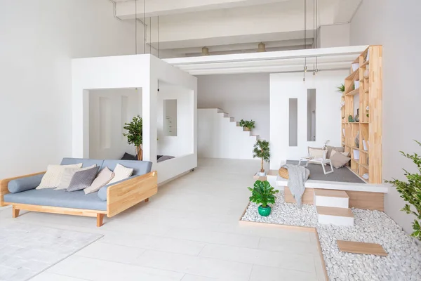 Luxury fashionable modern design studio apartment with a free layout in minimalistic style, bright spacious studio room white walls and wooden elements