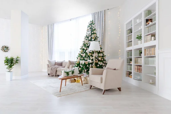 Luxury and expensive apartment interior in light colors. Stylish contemporary minimalistic design. Full of sun light. Decorated with Christmas tree