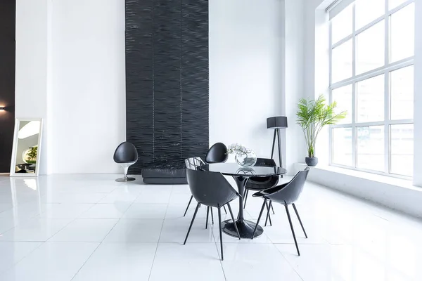 Luxury and trendy modern interior in contrasting black and white colors with fashionable and stylish black furniture
