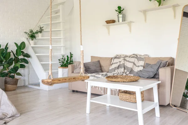 Luxury bedroom design in a rustic cottage in a minimalist style. white walls, panoramic windows, wooden elements of decoration on the ceiling, rope swings in the middle of a spacious room.