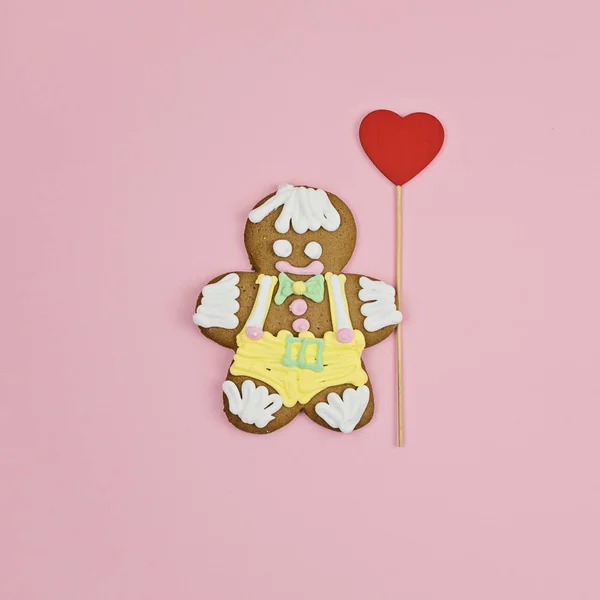 Large gingerbread man cookie with big red heart — Stock Photo, Image