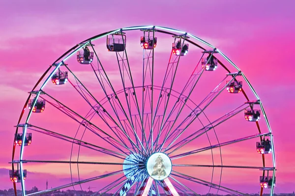 Närbild färgglada pariserhjul mot solnedgång rosa himmel. — Stockfoto
