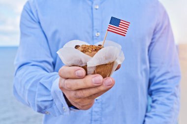 Erkek elinde minyatür Amerikan bayrağı olan yakın plan adam keki. Amerika 'da Başkanlık Günü kutlaması için tebrik kartı, Bağımsızlık Günü, Bayrak Günü Usa