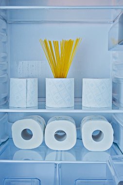 Dolabın raflarındaki tuvalet kağıdı ruloları ve spagetti histeri sembolü ve karantinaya alınmış Coronavirus Covid-19 'lar arasında aşırı alım.