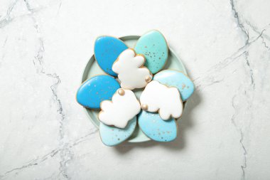 Paskalya kurabiyeleri bir tabak içinde beton bir arka planda. Bir bardak süt. Paskalya yumurtaları. Paskalya tavşanları. Metin için yer.