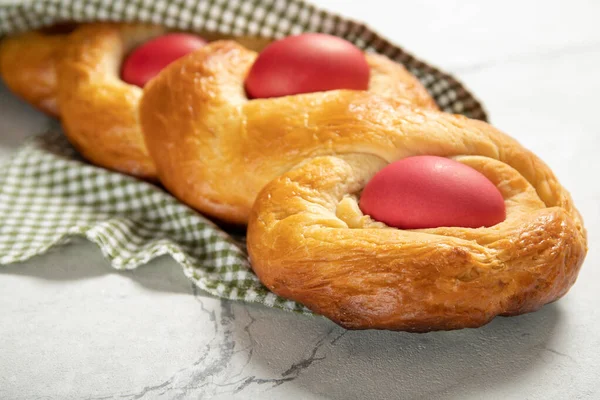 Tasty easter bread. Easter bread and red eggs. Italian easter bread.Close-up