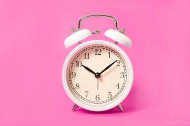 Pembe arka planda beyaz alarm saati. 