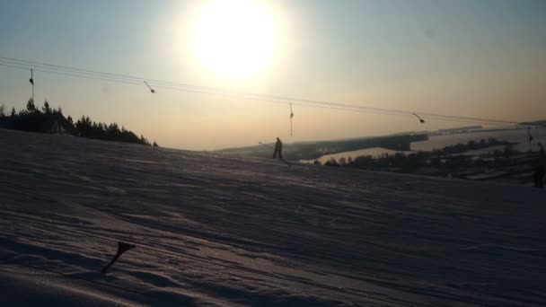 Зимние горки горнолыжный курорт, подъемник, спуск вниз сноубордистов и лыжников — стоковое видео
