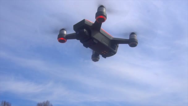 RC quadcopter hovers in the air, slow motion — Stock Video