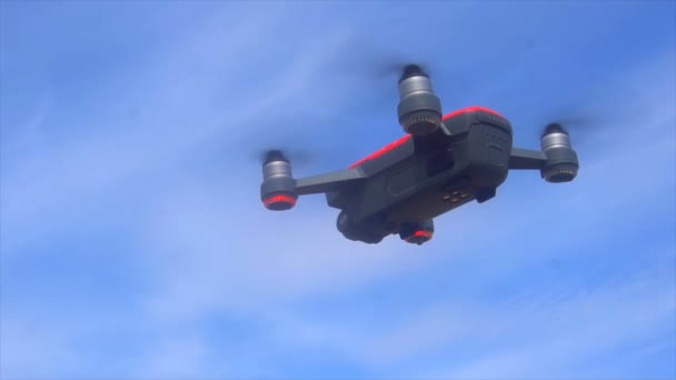 RC quadcopter hovers in the air, slow motion — Stock Video