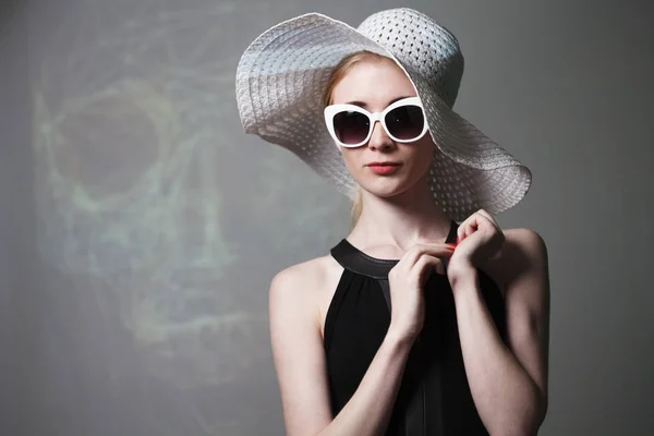 Jeune belle femme à la mode avec un maquillage à la mode. Modèle regardant la caméra, portant des lunettes élégantes, chapeau. Mode féminine, concept beauté . — Photo