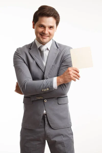 Joven hombre de negocios mostrando letrero, aislado en blanco . — Foto de Stock