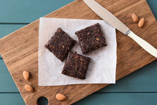 Vegan sweets. Homemade low calorie tasty brownies with almonds on wooden board