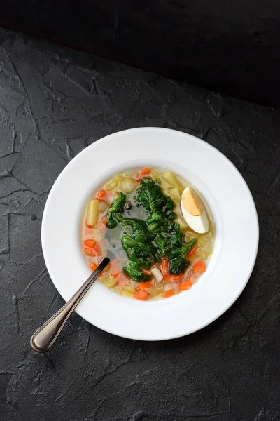 Wild herbs cooking. Homemade vegetarian soup with nettle and egg in white plate on black background top view copy space — Stock Image Wild Herbs Cooking Homemade Vegetarian Soup Nettle Egg White Plate Stock Image