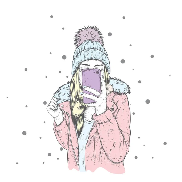 Şık bir ceket ve kabarık bubo ile güzel bir şapka aşağı bir kız. Bir kadın bir akıllı telefon tutarak ve selfies yapma. Vektör çizim. Giyim ve aksesuarları, moda ve stil.