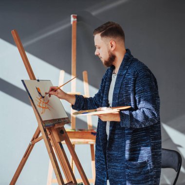 Stüdyoda resim yapan bir sanatçı.