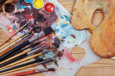 Sanat fırçası ve siyah arka planda renkli mürekkep kutuları. Kopyalama alanı olan üst görünüm.