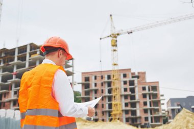 mimari ve ev yenileme kavramı - blueprint Fabrikası ile eldiven ve kask içinde adam.