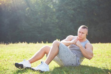 Genç bir sporcu dışarıda atletizm ve spor eğitimi için hazırlanıyor. Spor, egzersiz, spor, spor. Sağlıklı bir yaşam tarzı. Gün doğumunun erken saatleri.