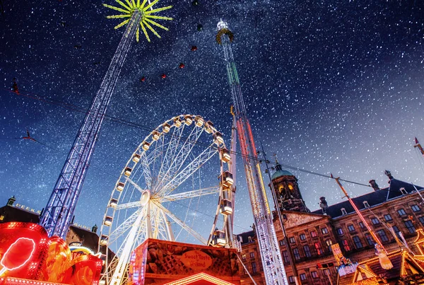 amusement park at the center of Amsterdam at night. Beautiful starry sky.