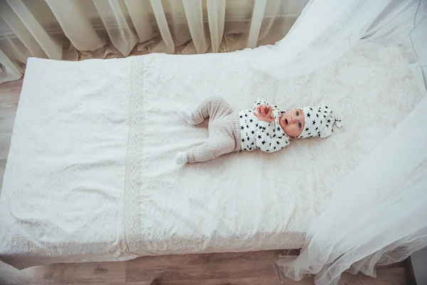 Newborn Baby Dressed White Suit Black Stars White Soft Bed — Stock Photo, Image