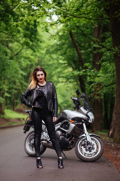 魅力的なセクシー女の子服を着た革のポーズ近くにAスポーツバイク外 — ストック写真