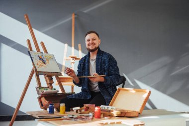 Stüdyoda resim yapan bir sanatçı.