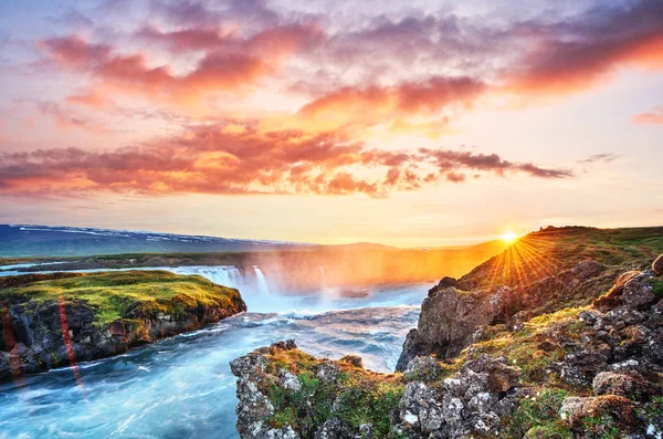 The picturesque sunset over landscapes and waterfalls. Kirkjufell mountain, Iceland