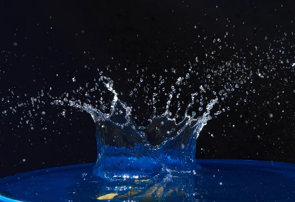Splash Korony Wody Niebieskiej Powierzchni Czarne Tło — Zdjęcie stockowe
