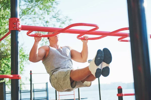 Homem Musculoso Com Belo Tronco Exercitando Barras Horizontais Fundo Parque — Fotografia de Stock
