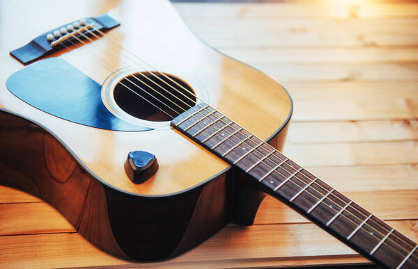 Photography classical guitar on a light brown background.