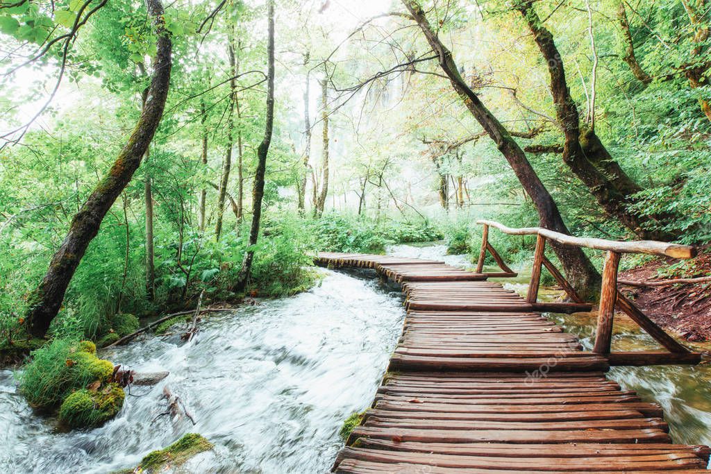 Plitvice Lakes National Park, tourist route on the wooden flooring along the waterfall, Croatia