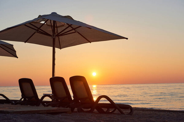 Scenic view of sandy beach on the beach with sun beds and umbrellas open against the sea and mountains. Hotel. Resort. Tekirova-Kemer. Turkey