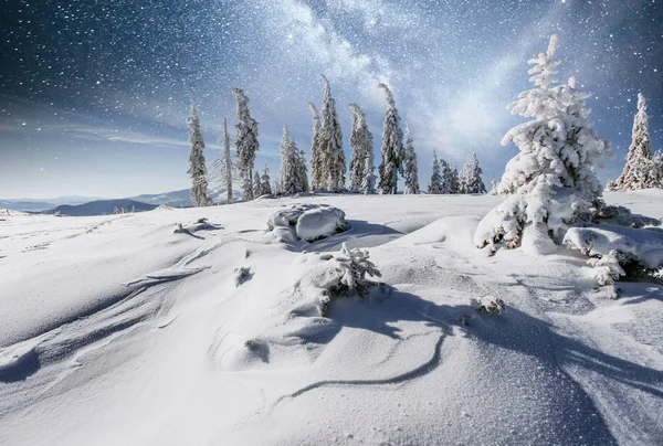 starry sky in winter snowy night. fantastic milky way in the New Year\'s Eve. Starry sky snowy winter night. The Milky Way is a fantastic New Year\'s Eve. Winter road in the mountains