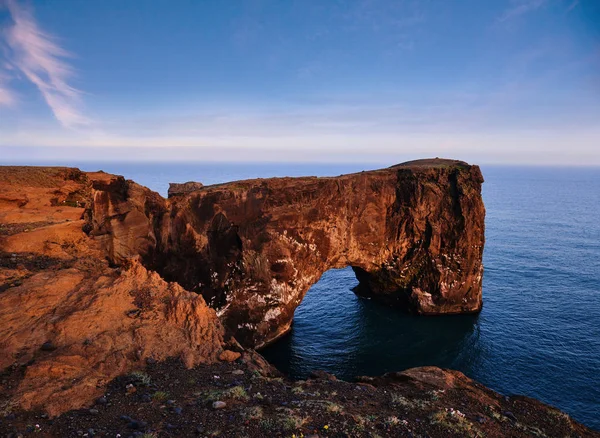 stock image Cape Dyrholaey at southern Iceland. Altitude 120 m, and mean hill island with a door opening.