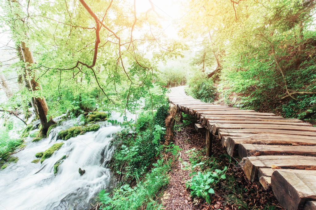 Plitvice Lakes National Park, tourist route on the wooden flooring along the waterfall, Croatia