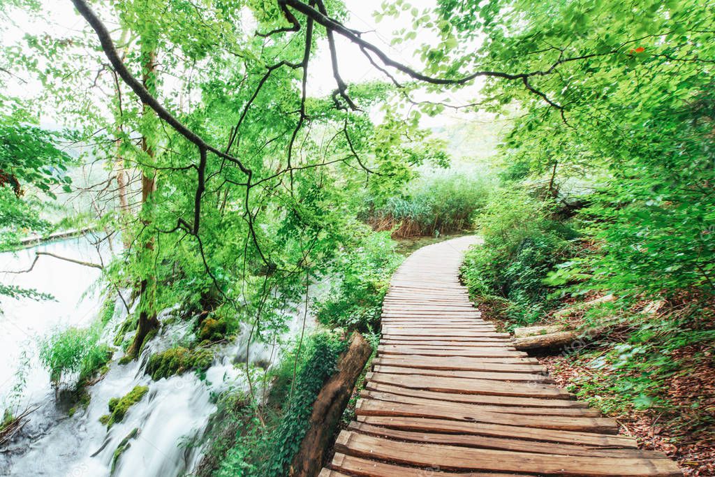 Plitvice Lakes National Park, tourist route on the wooden flooring along the waterfall, Croatia