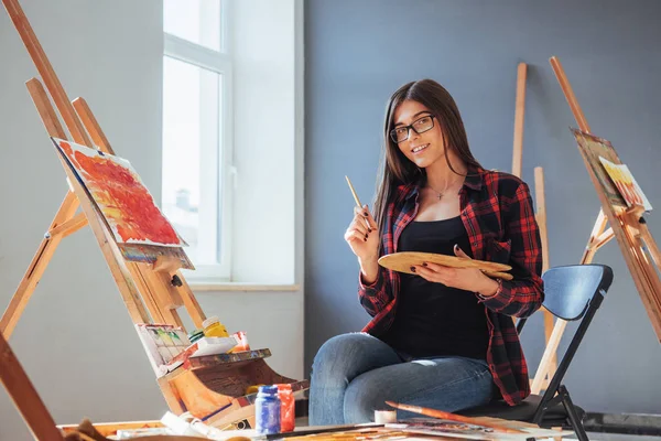 Dark Haired Artist Holding Brush His Hand Draws Picture Canvas — Stock Photo, Image