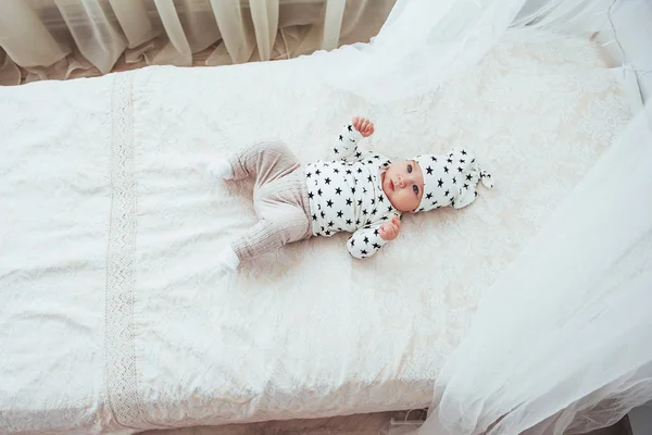 Newborn Baby Dressed White Suit Black Stars White Soft Bed — Stock Photo, Image