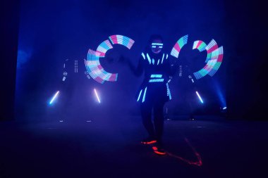 Laser show performance, dancers in led suits with LED lamp, very beautiful night club performance, party.