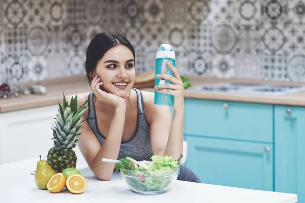 Beautiful woman with healthy food fruit in the kitchen.