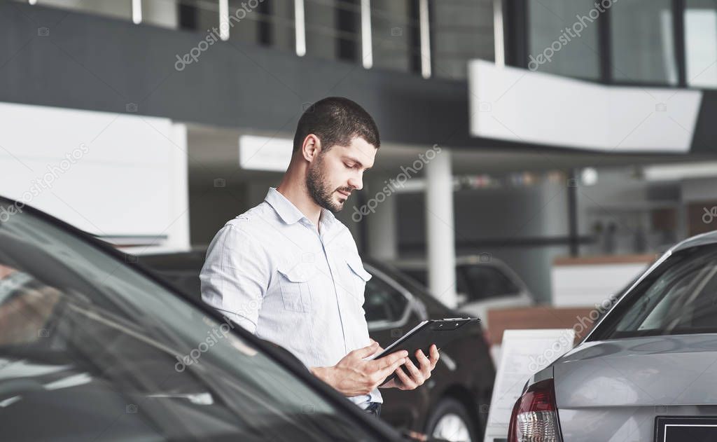 Young sellers with a folder for selling a new car.