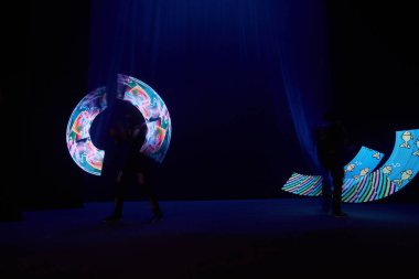 Laser show performance, dancers in led suits with LED lamp, very beautiful night club performance, party.