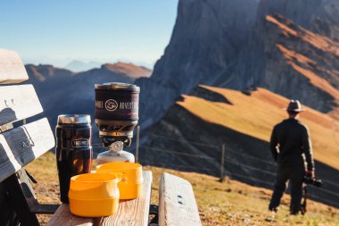 Such an awesome view. Touristic place with bench and cups at Seceda mountains. clipart