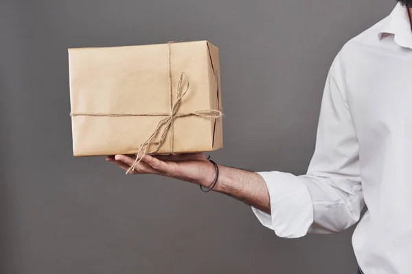 Man Hands Gives Parcel Wrapped Brown Paper Tied Rough Twine — Stock Photo, Image