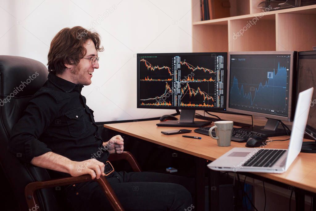 Businessmen trading stocks online. Stock broker looking at graphs, indexes and numbers on multiple computer screens. Business success concept.