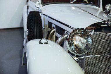 Sinsheim, Almanya - 16 Ekim 2018: Technik Müzesi. Yan tarafında yedek tekerlek olan eski model beyaz otomobilin kırpılmış fotoğrafı.