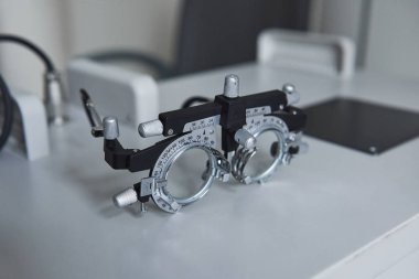 Ophthalmic glasses laying on the white table in the clinic. clipart