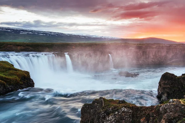 The picturesque sunset over landscapes and waterfalls. Kirkjufell mountain, Iceland.