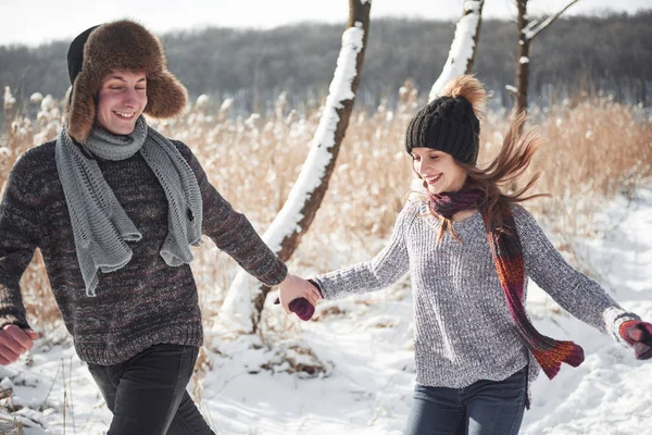 Happy Young Couple in Winter Park having fun.Family Outdoors. love